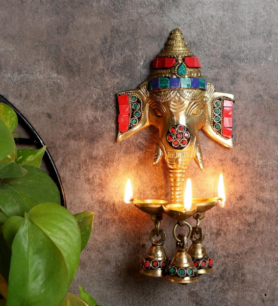 Brass Ganesha Diya wall hanging with three bells and detailed stone work for pooja spaces