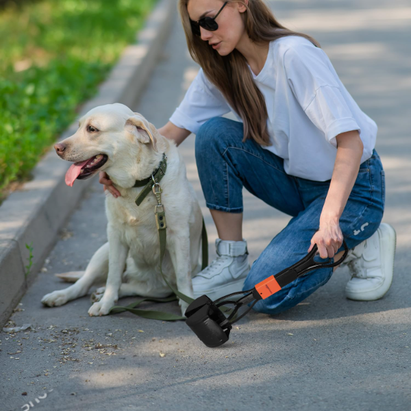 Folding jaw poop scooper displaying hanging hook handle for tidy storage after pet waste collection