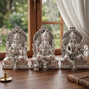 Silver-plated Lakshmi Ganesh Saraswati idol with detailed finish and attached base for home temple