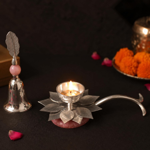 Silver diya gift set featuring a lotus-shaped holder with engraved leaf detailing and pink bead