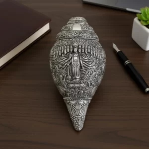 Antique silver shankh with Virat Roop of Vishnu for a traditional Hindu mandir pooja setting