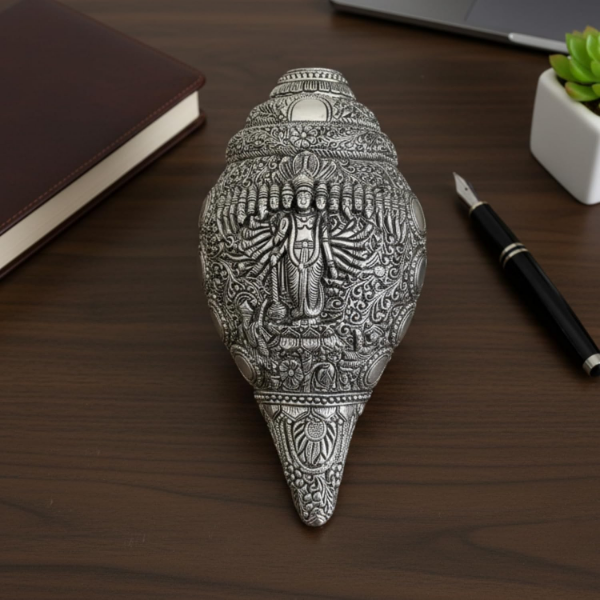 Antique silver shankh with Virat Roop of Vishnu for a traditional Hindu mandir pooja setting